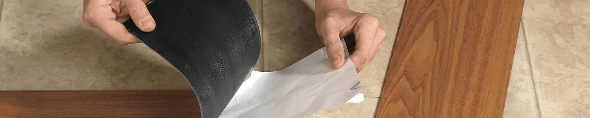 A professional installing vinyl flooring in Jackson, MS